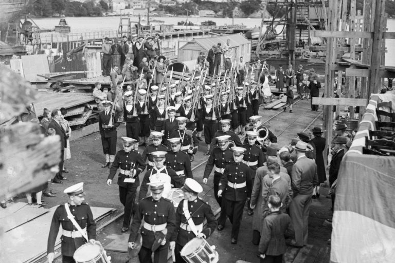 Royal Marine Band at ease after the delivery ceremony for HMNZS Waikato (T30) in 1944. The Royal Marines served with the RNZN for 36 years prior to when our own RNZN band was established in 1960. HNZS Waikato (I) was never commissioned into the RNZN as she was considered surplus to the war effort.