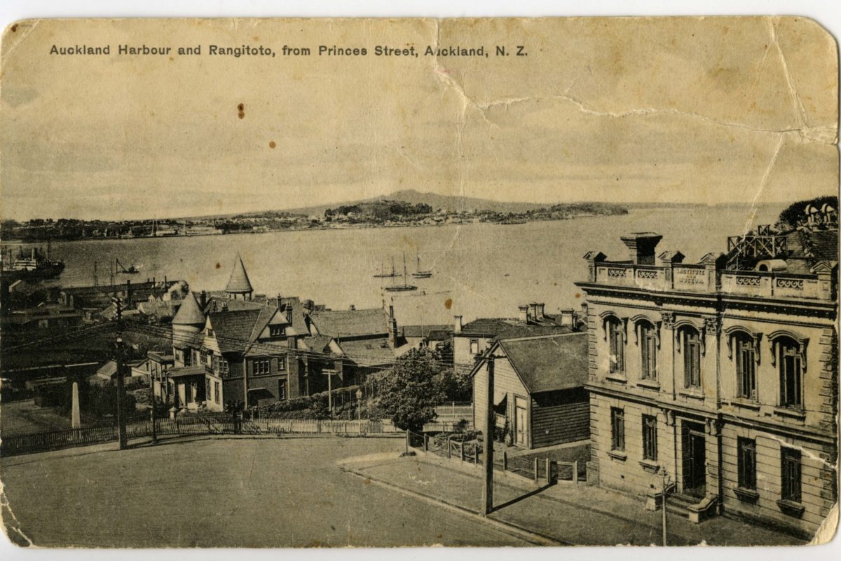 Postcard of 'Auckland Harbour and Rangitoto from Princes Street, Auckland, NZ.' showing Admiralty House in the centre as well as the old Auckland Museum building and caretakers house on Princes Street (right foreground).