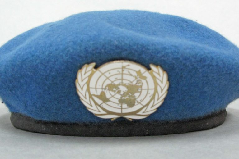 Blue United Nations beret with white UN badge. Issued to LT CDR Campbell, Officer in Charge of UNTAC (United Nations Transitional Authority in Cambodia) Team One.