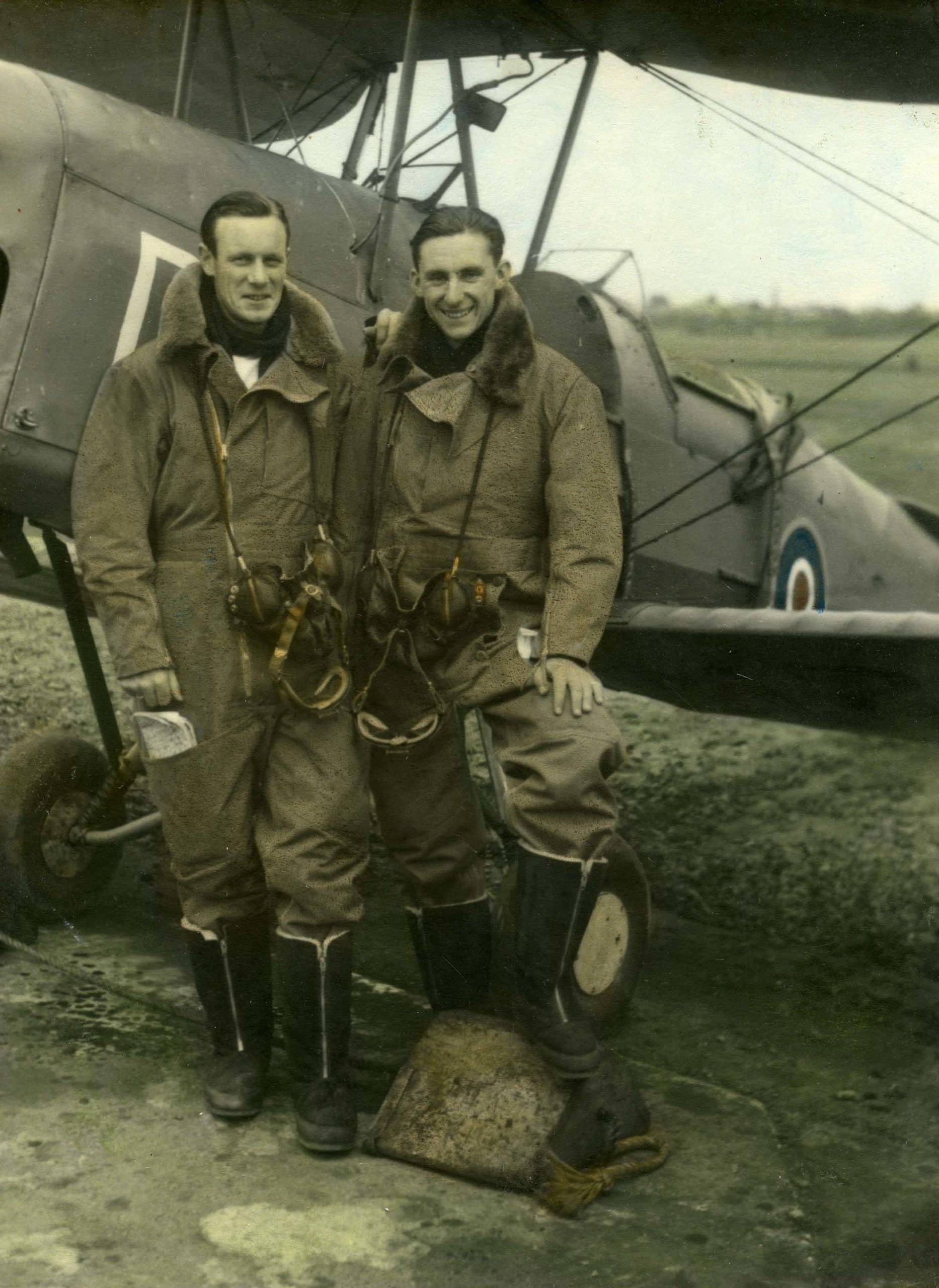 FAA Pilots SLT (A) Rod Thompson RNZNVR & SLT (A) J. Pollock RNZNVR in full flying kit beside a Tiger Moth Trainer at RNZAS Elmdon - now Birmingham Airport