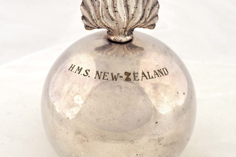FT-0244 Silver lighter shaped like a grenade. Engraved are the words ‘HMS NEW ZEALAND‘.
