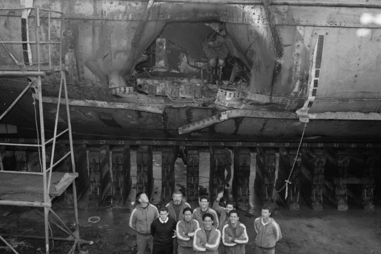 GN 85 01490 01 LT Hugh Aitken and Navy Dive Team standing in Calliope Dock in front of the hole in the Rainbow Warrior