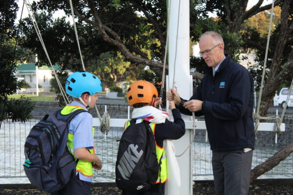 David and two young locals keen to have a go at raising the White Ensign.  2025