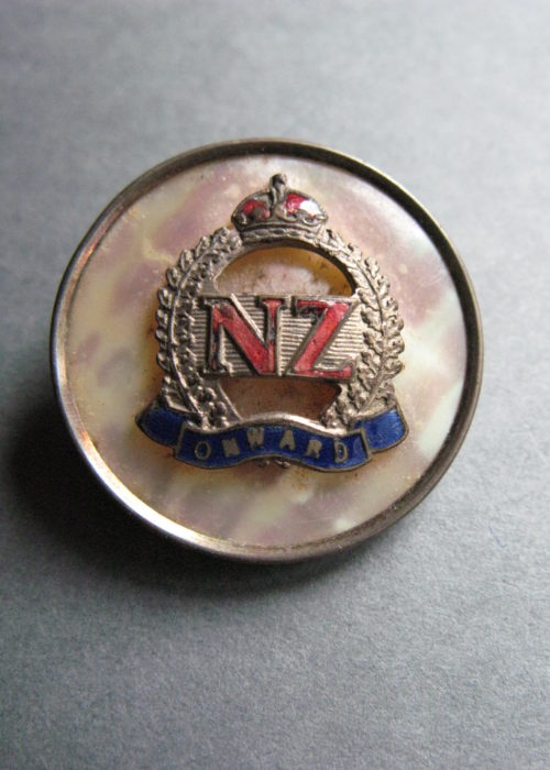 Circular silver bordered mother of pearl brooch