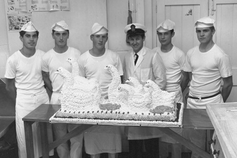 Petty Officer Cook and trainees with swan cakes in July of 1970.