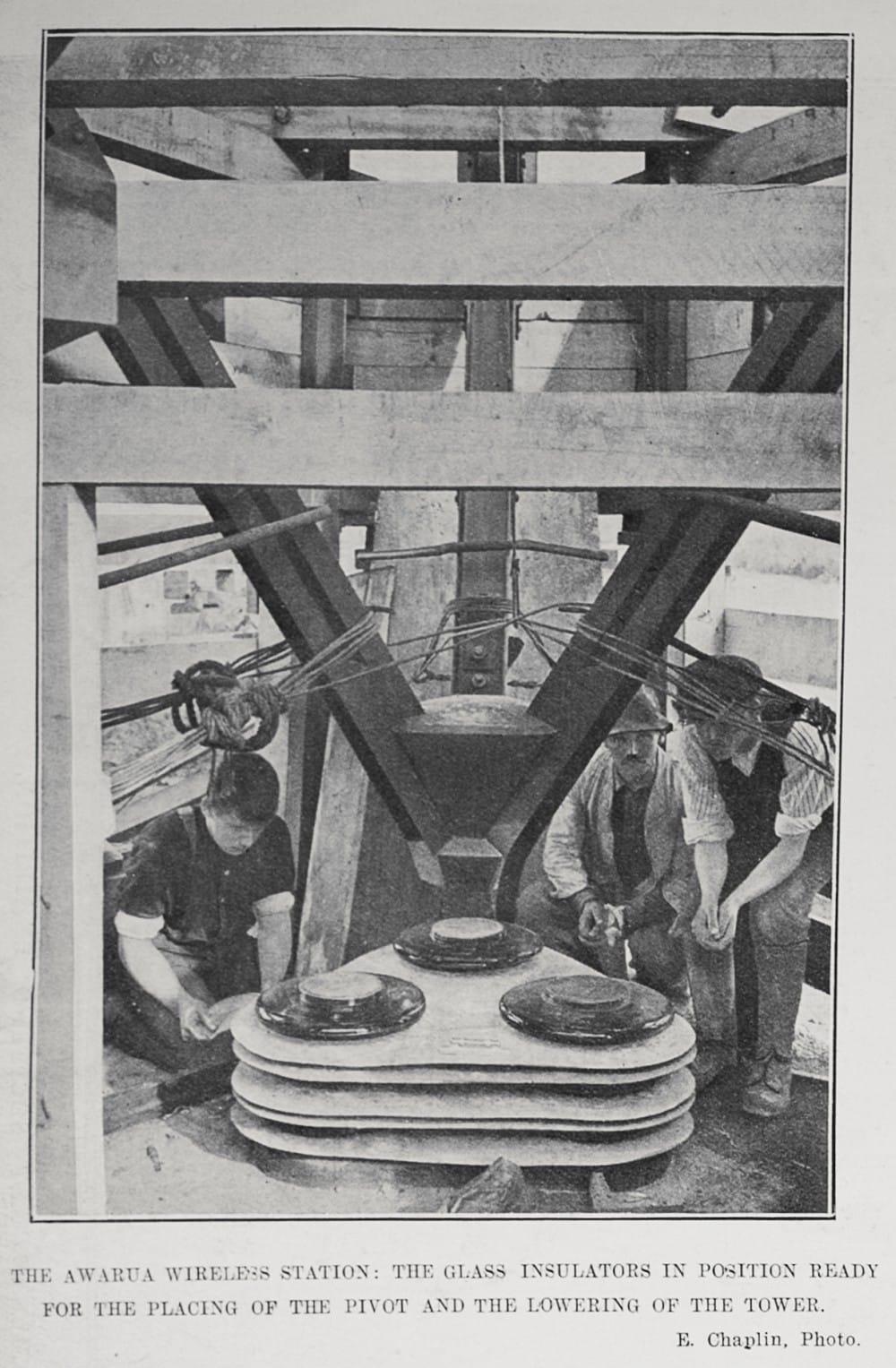 Showing a scene at the Awarua Wireless Station: The glass insulators in position ready for the placing of the pivot and the lowering of the tower. Sir George Grey Special Collections, Auckland Libraries, AWNS-19130529-14-1 Awarua Wireless Station: The glass insulators in position ready for the placing of the pivot and the lowering of the tower.
