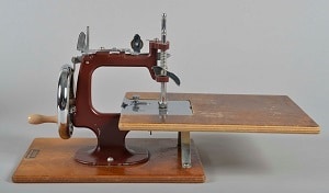 Essex Miniature Sewing Machine Essex miniature sewing machine, displayed with flatbed attachment.